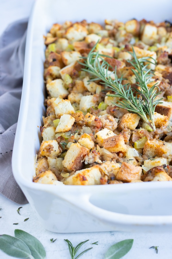 Sausage stuffing is topped with fresh herbs