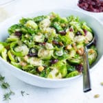 Vegetarian Brussels sprout salad is served in a bowl at Thanksgiving.