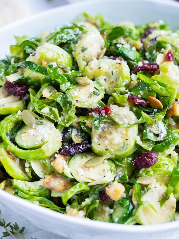 Shaved Brussels sprout salad is served in a bowl for a healthy side dish.
