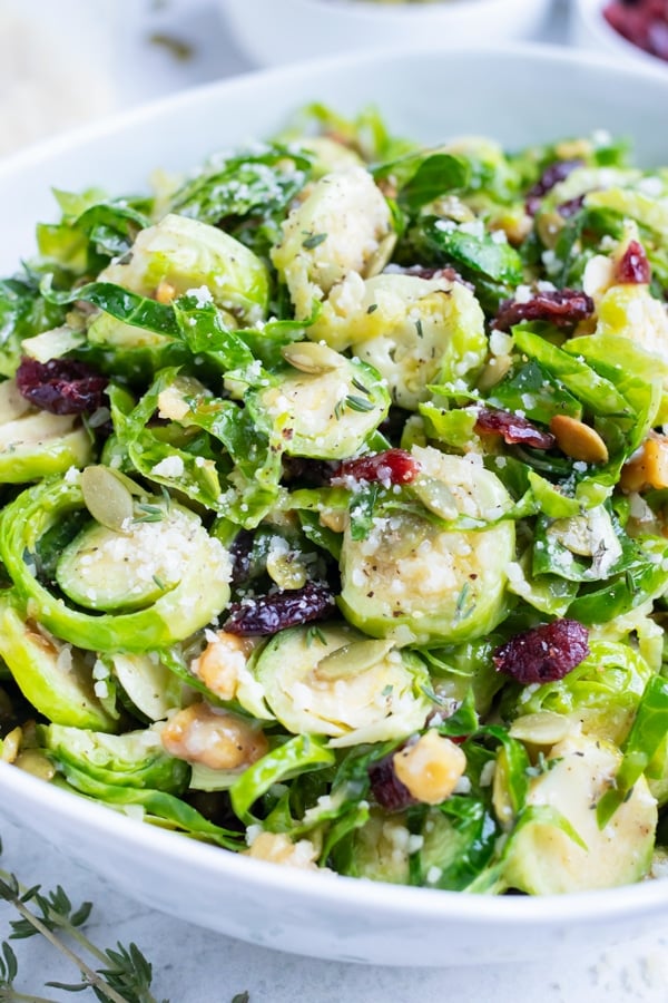 Shaved Brussels sprout salad is served in a bowl for a healthy side dish.