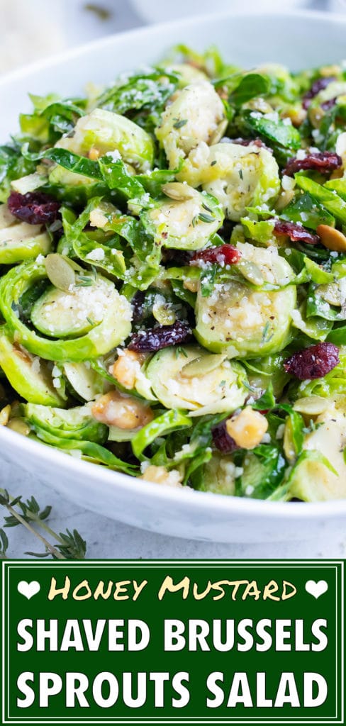 Shredded Brussels sprouts salad is served cold in a large white bowl.