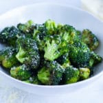 Air fryer broccoli is served in a white bowl for a low-carb side.