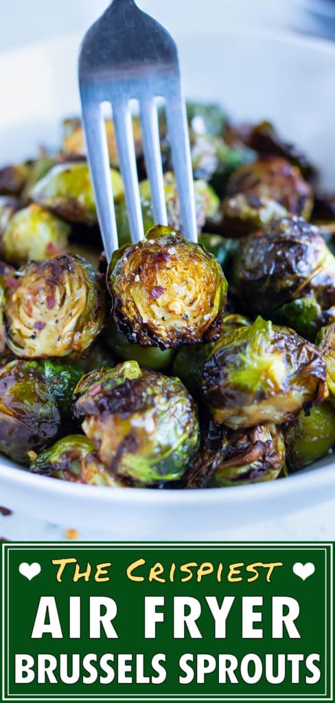 A crispy brussels sprout is lifted up by a fork out of a bowl.