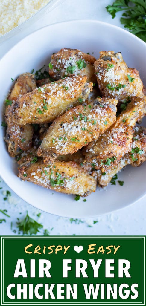 Chicken wings are lifted up by a hand for a low-carb appetizer.