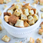 Easy homemade croutons are placed in a bowl before adding to soups and salads.