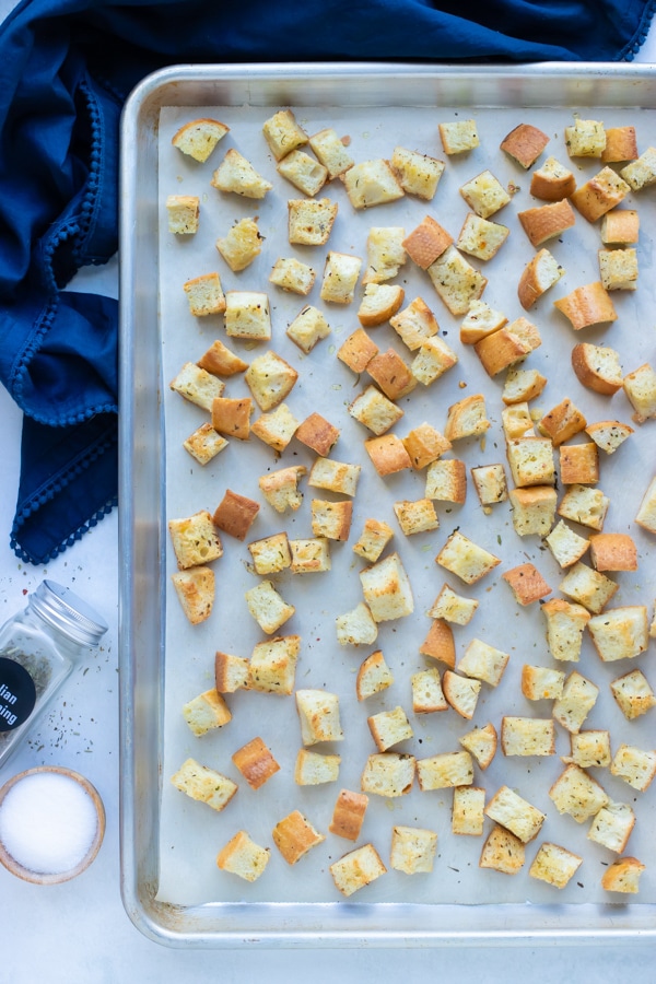 Easy gluten-free croutons are baked on a sheet pan in the oven for 15 minutes.