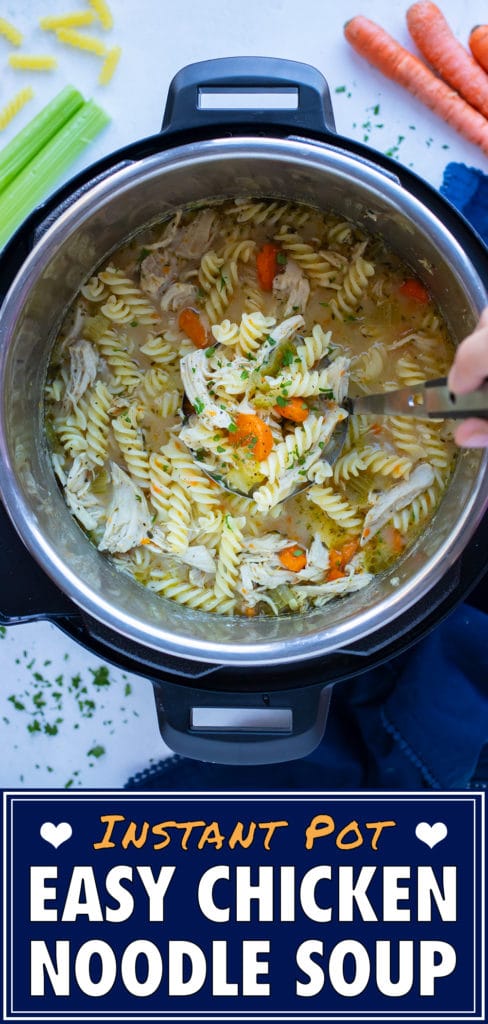 Healthy chicken noodle soup is stirred with a metal spoon in the instant pot.