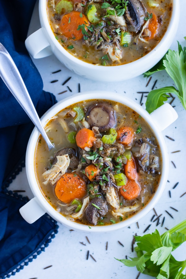 Healthy pressure cooker soup is served in a white bowl with a spoon for an easy meal.