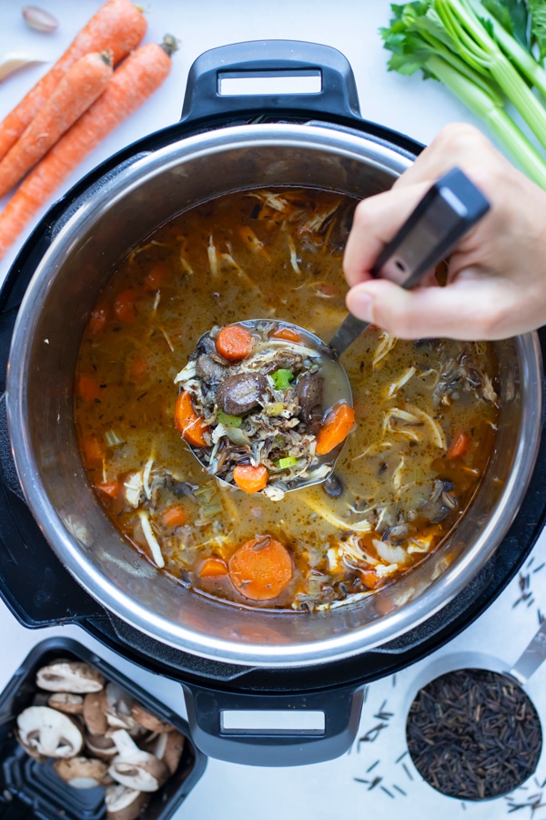 Chicken wild rice soup is cooked in a pressure cooker for a quick and easy meal.