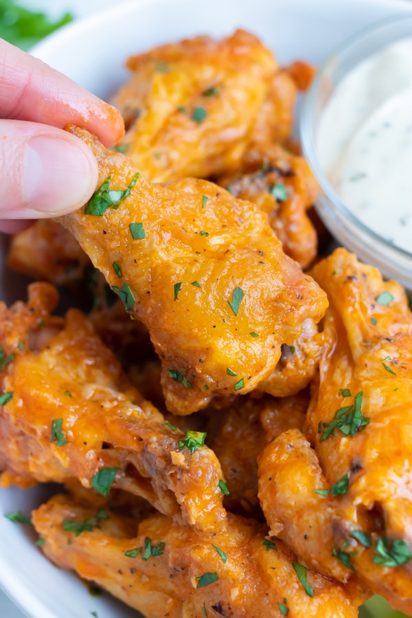 Oven baked buffalo chicken wings are served as game day food.