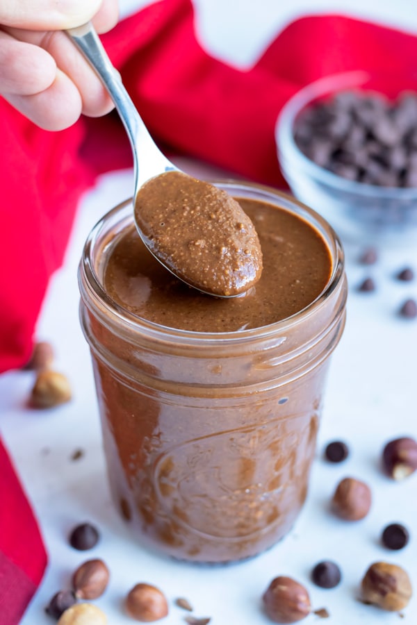 Chocolate hazenut butter is served with a spoon for a healthy nutella alternative.