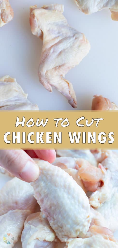 A wingette is lifted up by a hand out of a pile of cut chicken wings.