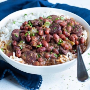 Instant pot red beans and rice are served for dinner in a white bowl.