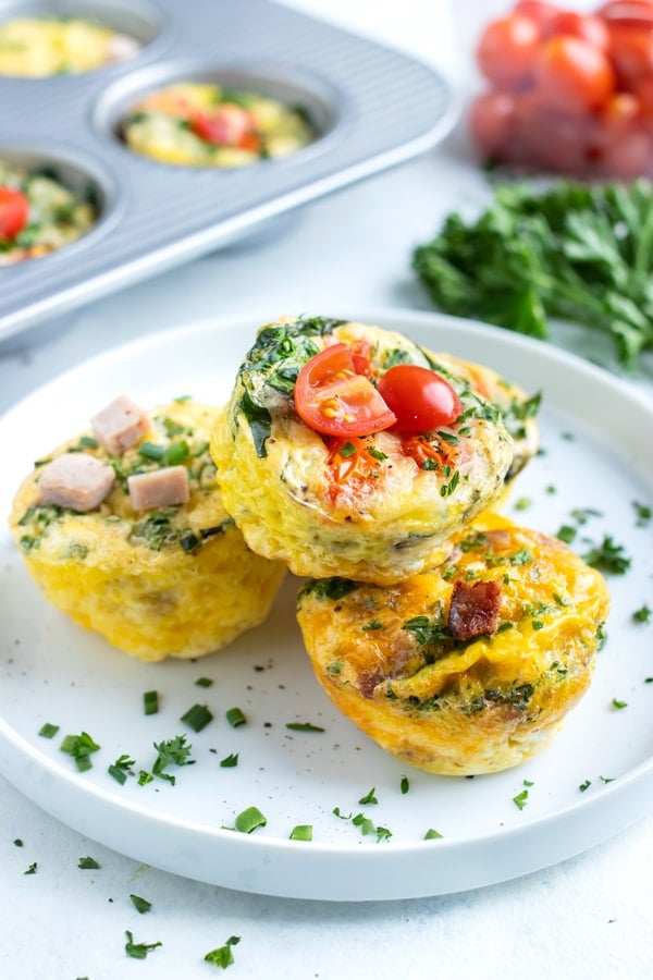 A plate of egg muffins are stacked for a low-carb, keto breakfast dish.
