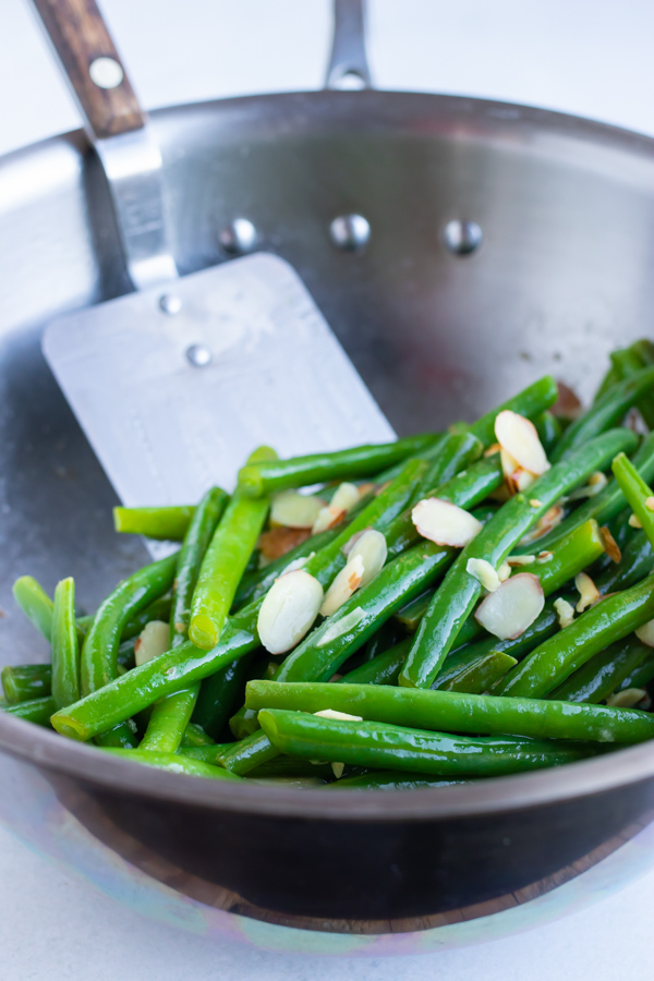 Green beans almondine in a skillet.
