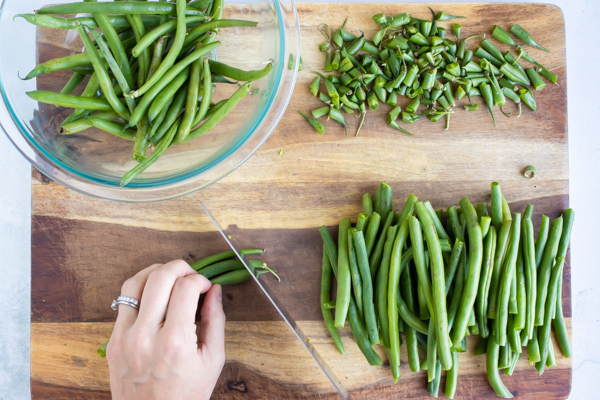 Trimming the stem end from green beans for boiling and blanching.