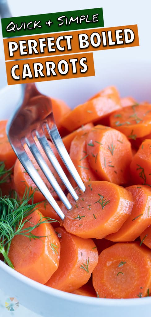 A sliced boil carrot is served with a fork.