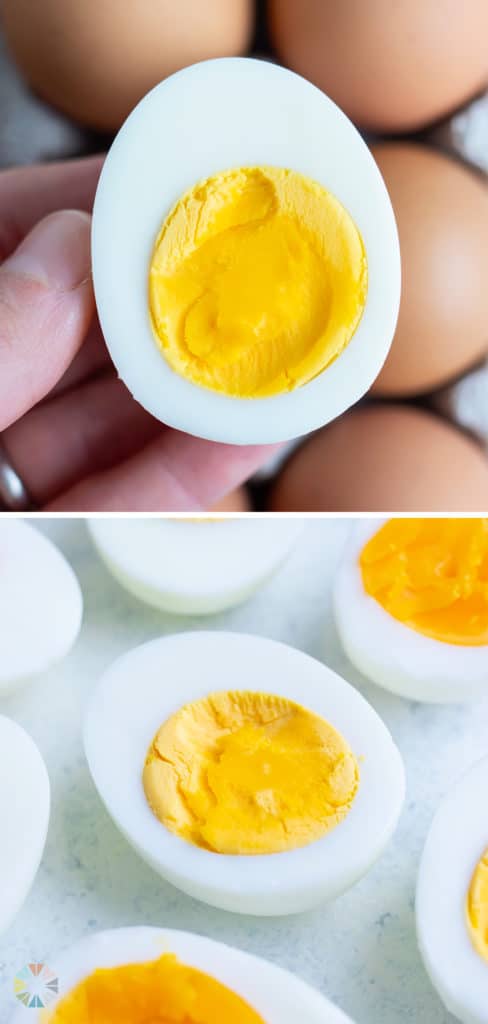 A hard-boiled egg is held by a hand with more eggs behind it.
