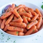A bowl of pressure cooker glazed carrots are served for an Easter side.