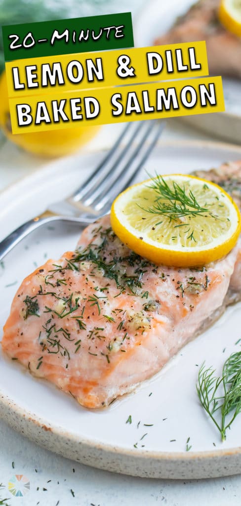 Salmon is served on a a white plate with a fork.