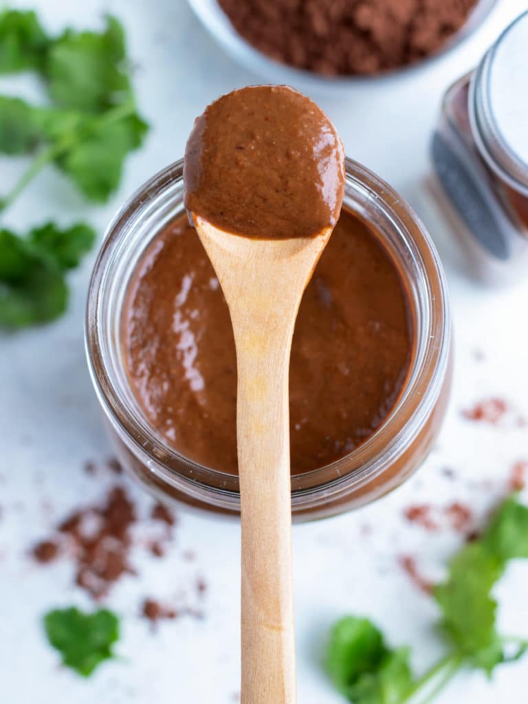 20-Minute Mole sauce is shown on a wooden spoon.