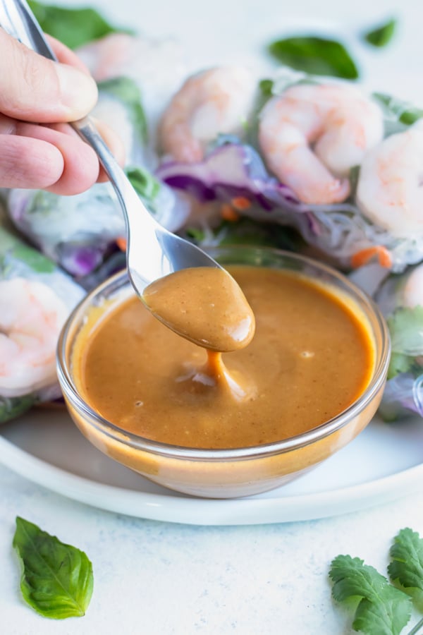A spoon is used to serve this easy peanut sauce.