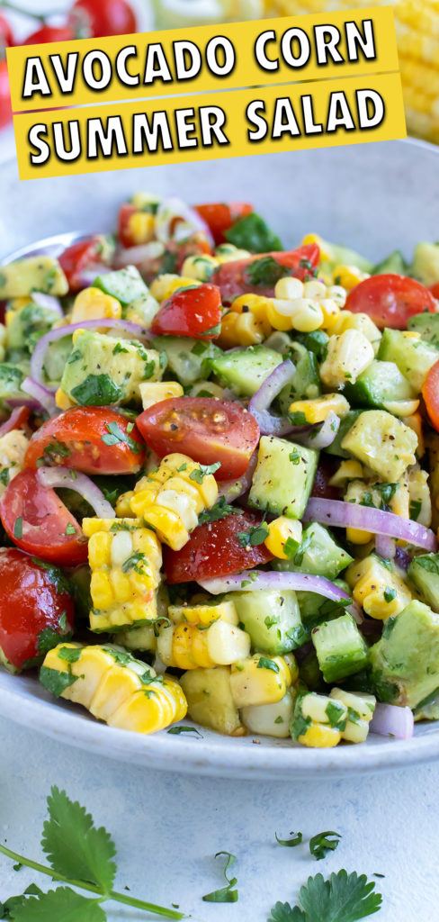 Avocado corn salad is dished from a glass bowl for a picnic or BBQ side dish.