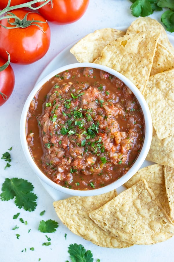 Tortilla chips are served with a big bowl of homemade salsa.