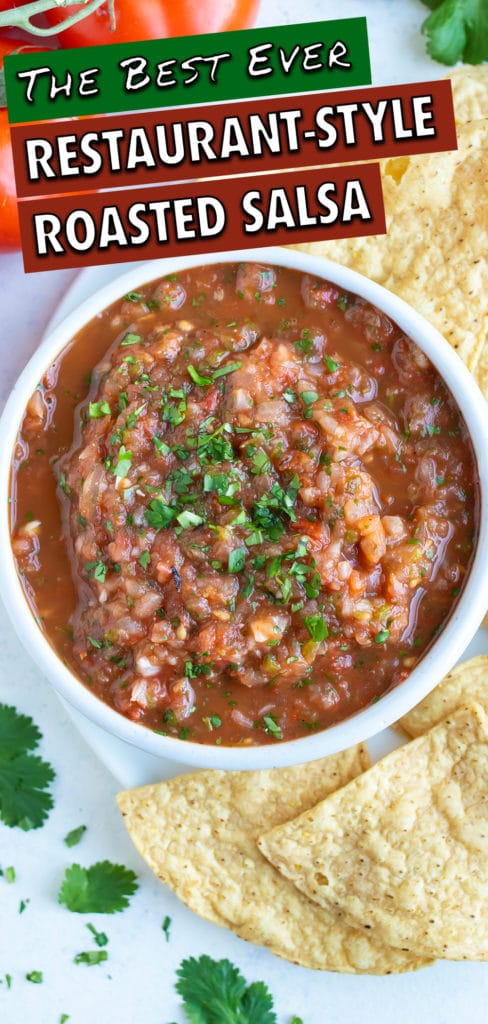 Healthy roasted tomato salsa is served in a white bowl with chips for a snack.