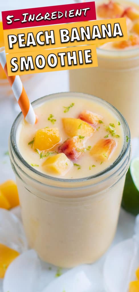 Peach smoothie shown next to a lime and ice cubes for a frozen drink.