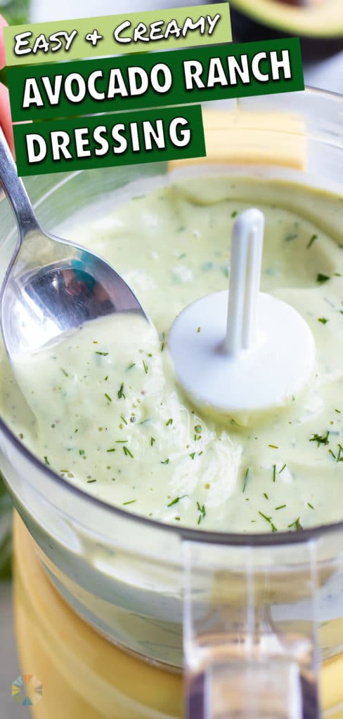 Homemade avocado dip is scooped up with a metal spoon.