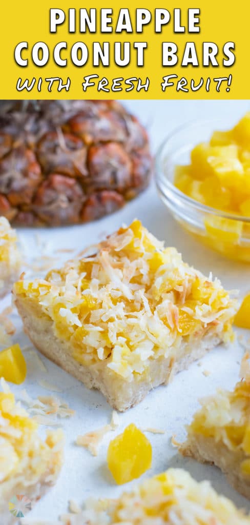 Pineapple dessert bars are stacked on each other on the counter.