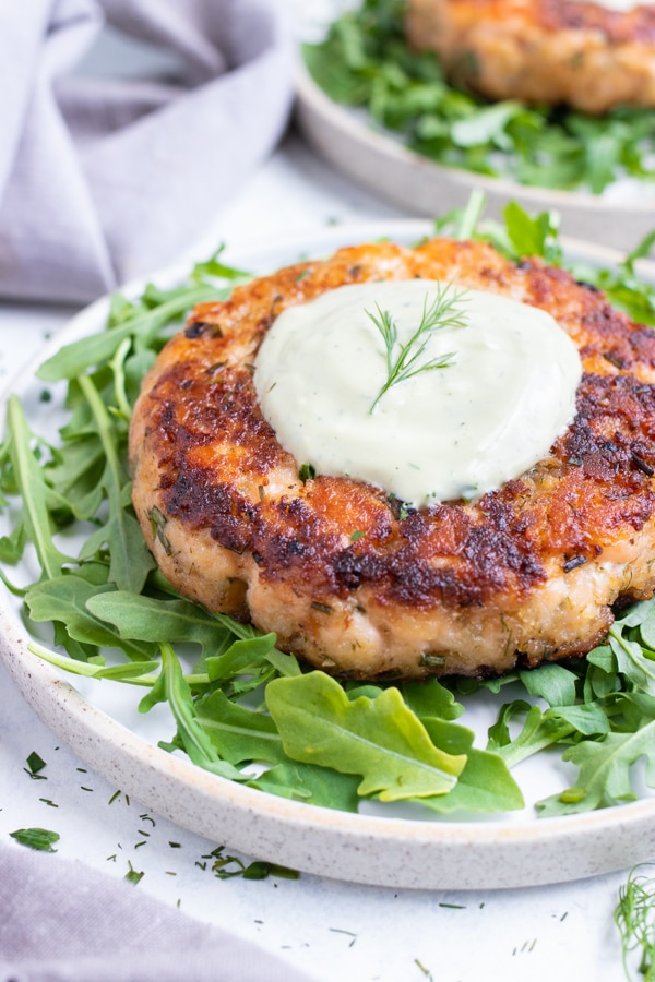 Salmon burger and homemade avocado ranch are served for a low-carb meal.