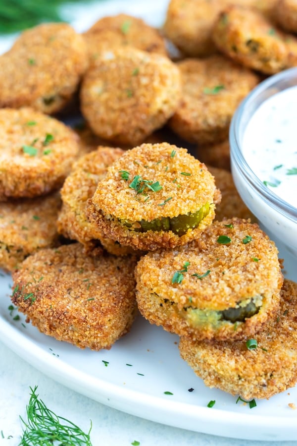 A plate of air fryer pickles is set on the counter for a low-fat recipe.