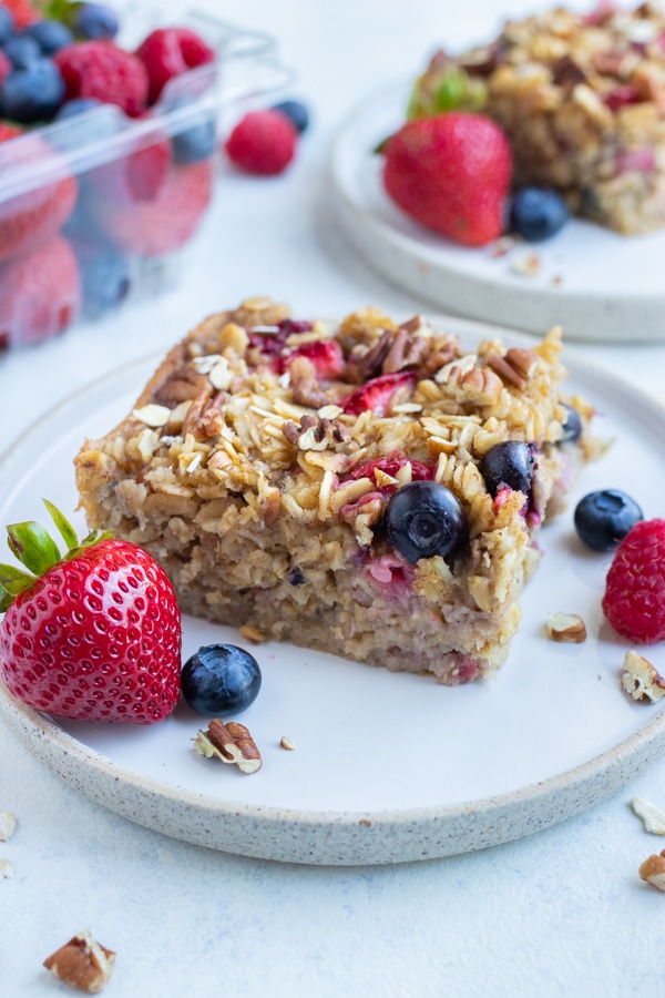 A square of baked oatmeal is served on a plate for breakfast.