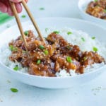 Chopsticks are used to enjoy this homemade General Tso's Chicken.