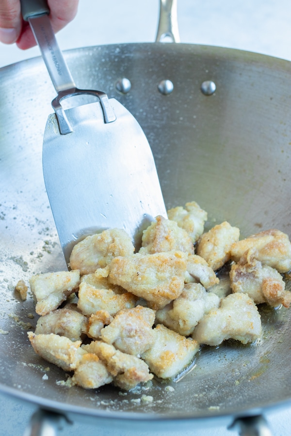 The chicken is cooked in a skillet on the stove.