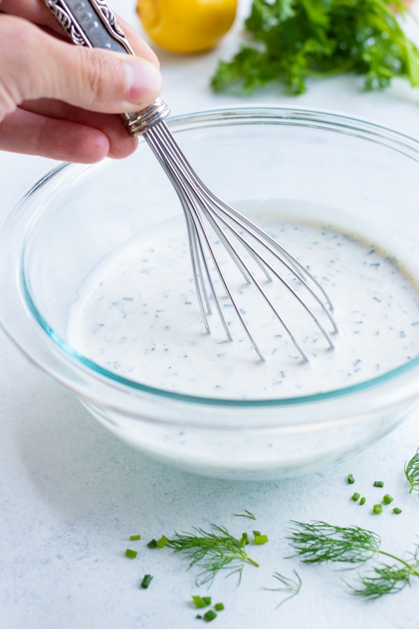 Homemade ranch ingredients are combined with a whisk until creamy.