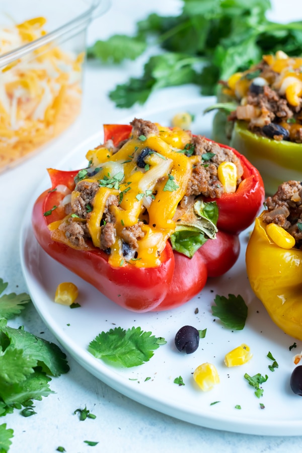 Taco stuffed bell peppers are served on a plate.