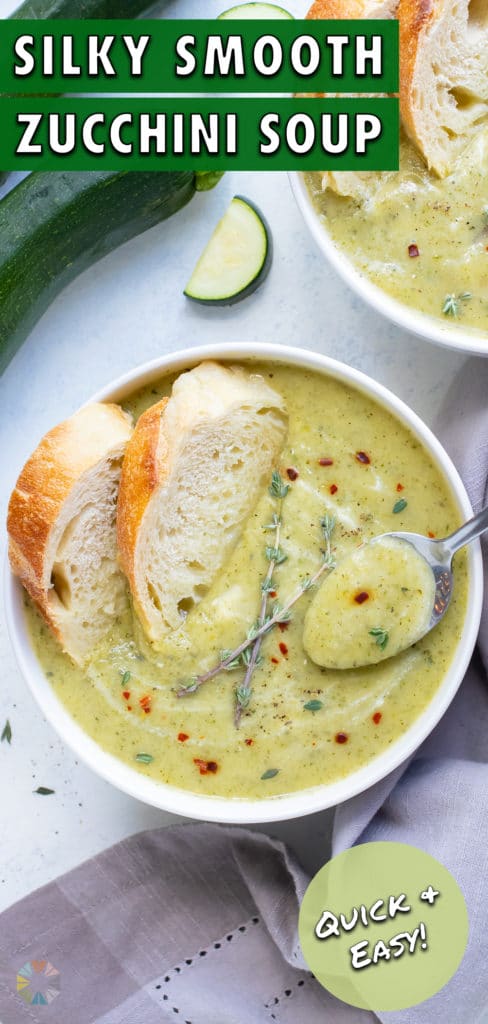A bowl of zucchini soup is enjoyed with bread.