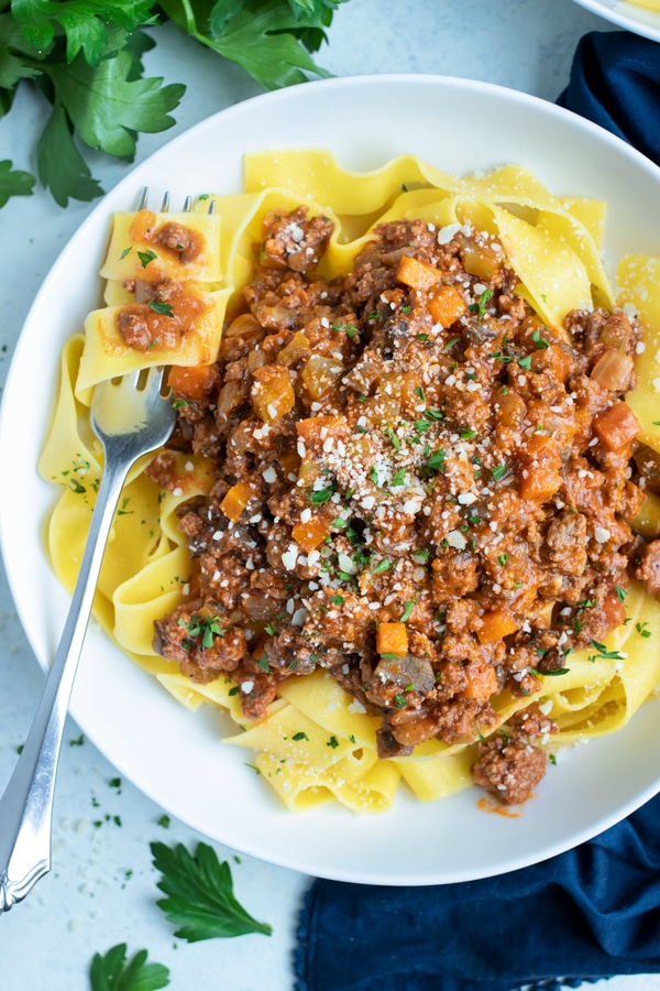 Bolognese sauce is served with noodles for an Italian dish.
