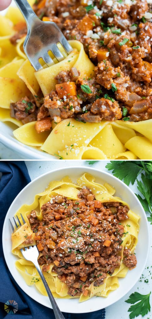 A bowl of bolognese sauce is topped with fresh grated Parmesan cheese.