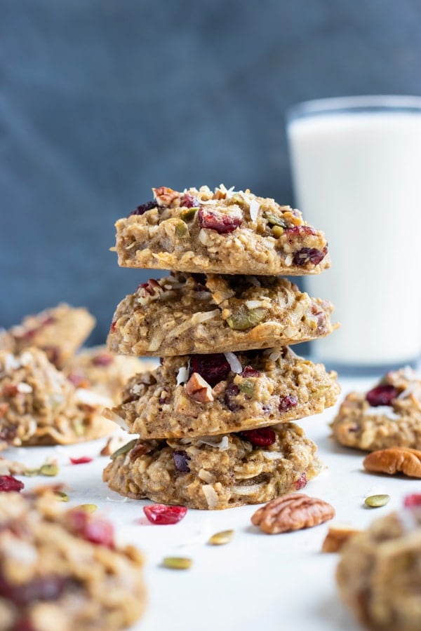 Oatmeal breakfast cookies are shown in a stack with a glass of milk.