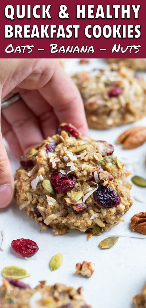 A hand is used to grab a healthy breakfast cookie for an on-the-go morning treat.