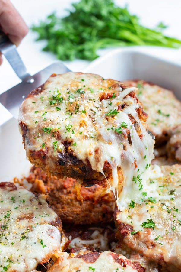 Eggplant parmesan is served with a spatula.