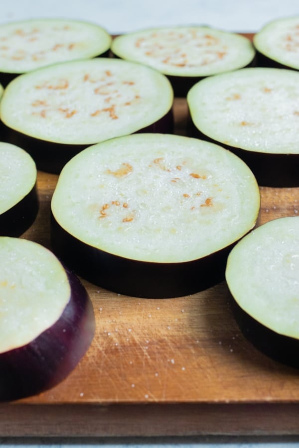 Salt is added to the raw eggplant.