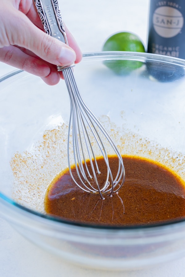 Marinade is whisked together in a bowl.