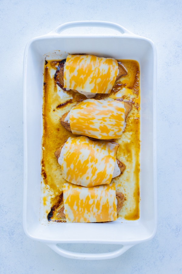 Sliced cheese is then placed over the fiesta chicken breasts.