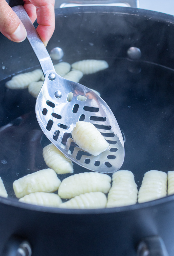 Gnocchi is boiled in a pot before it floats.