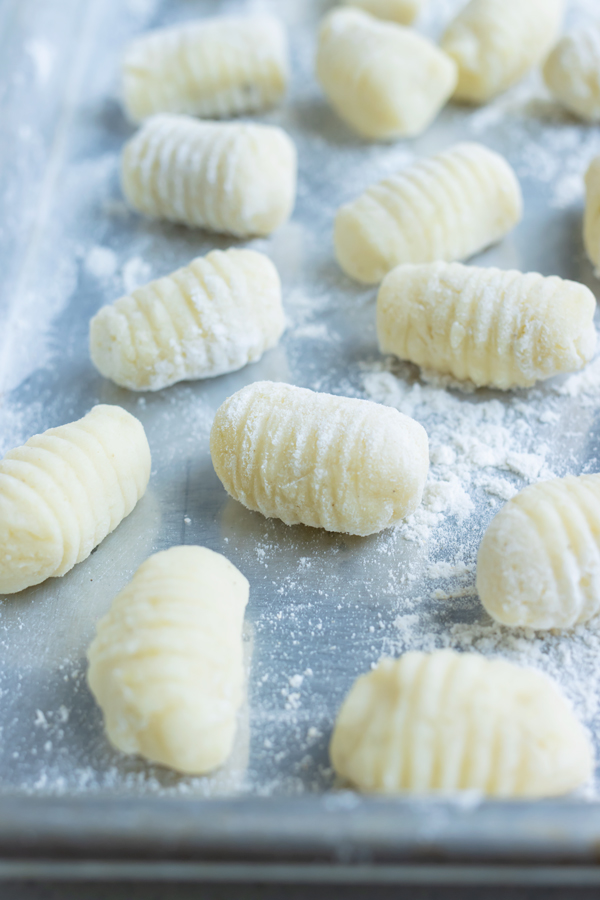 Shaped gnocchi is set on a pan before cooking.
